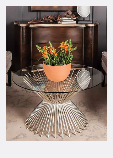 modern metalic coffee table with a glass top and a terracotta flower pot