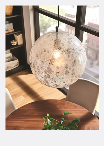 textured glass pendant hanging over a wooden table