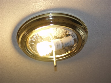 Light bulb screwed into light fixture and on